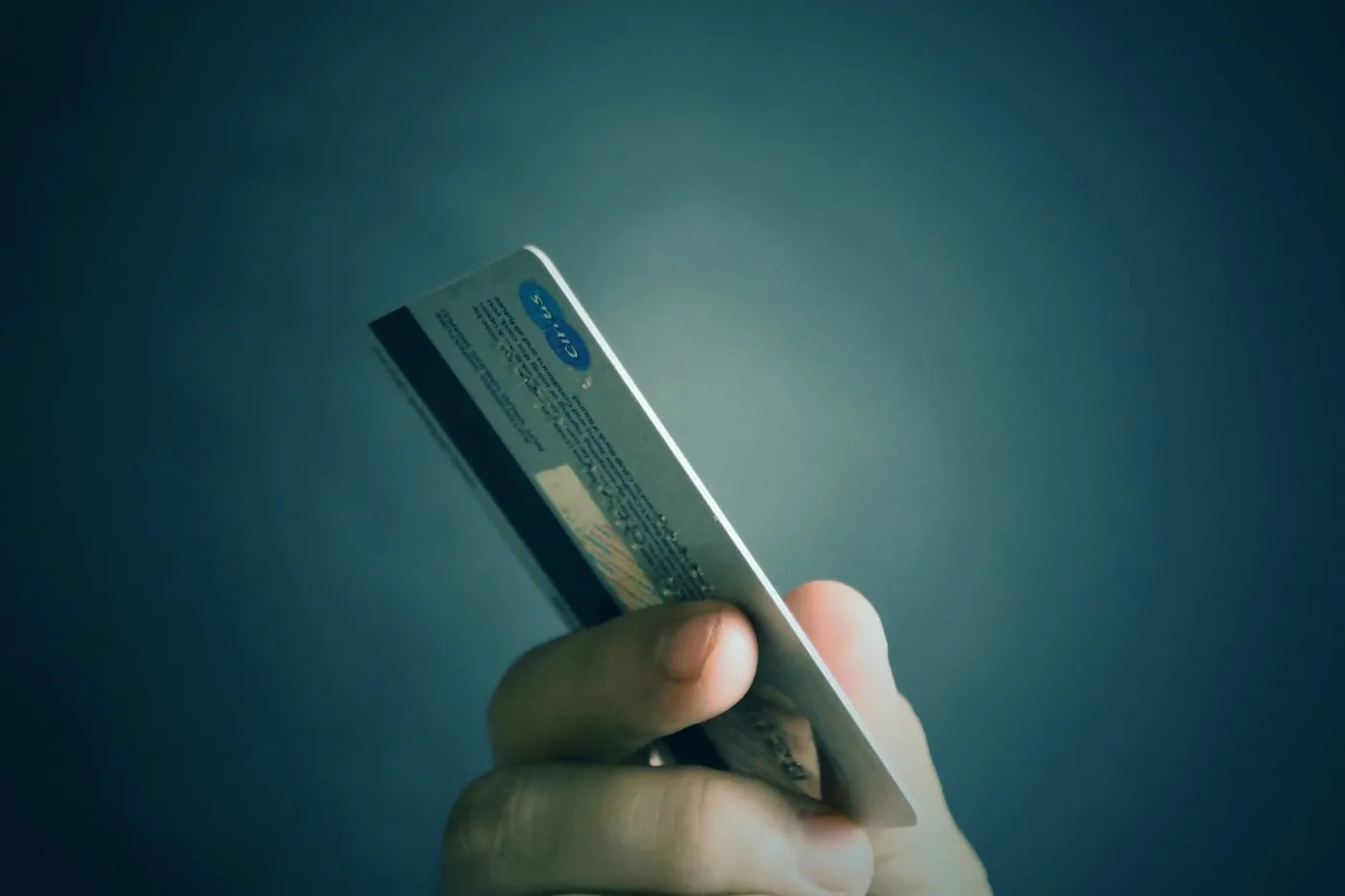 Hand holding up a credit card