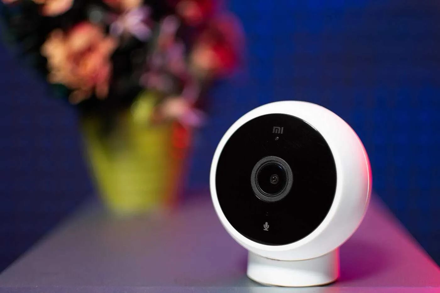 White smart home security camera on a table